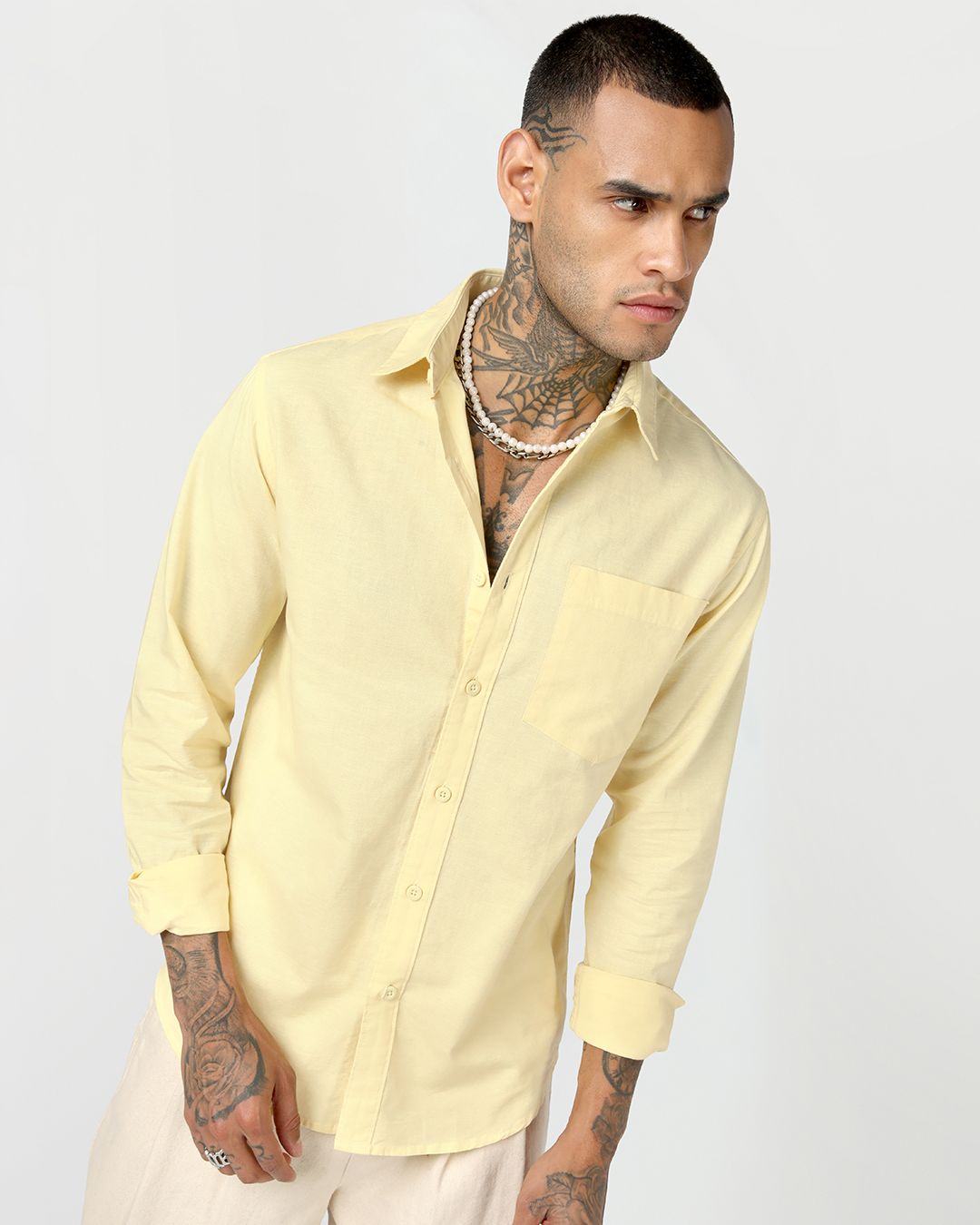 men styling yellow shirt with a cream pant