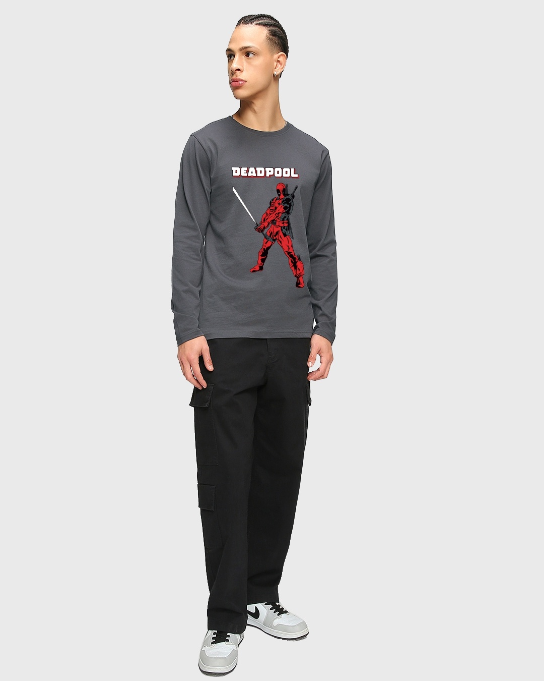 man posing with deadpool t-shirt paired with matching sneakers