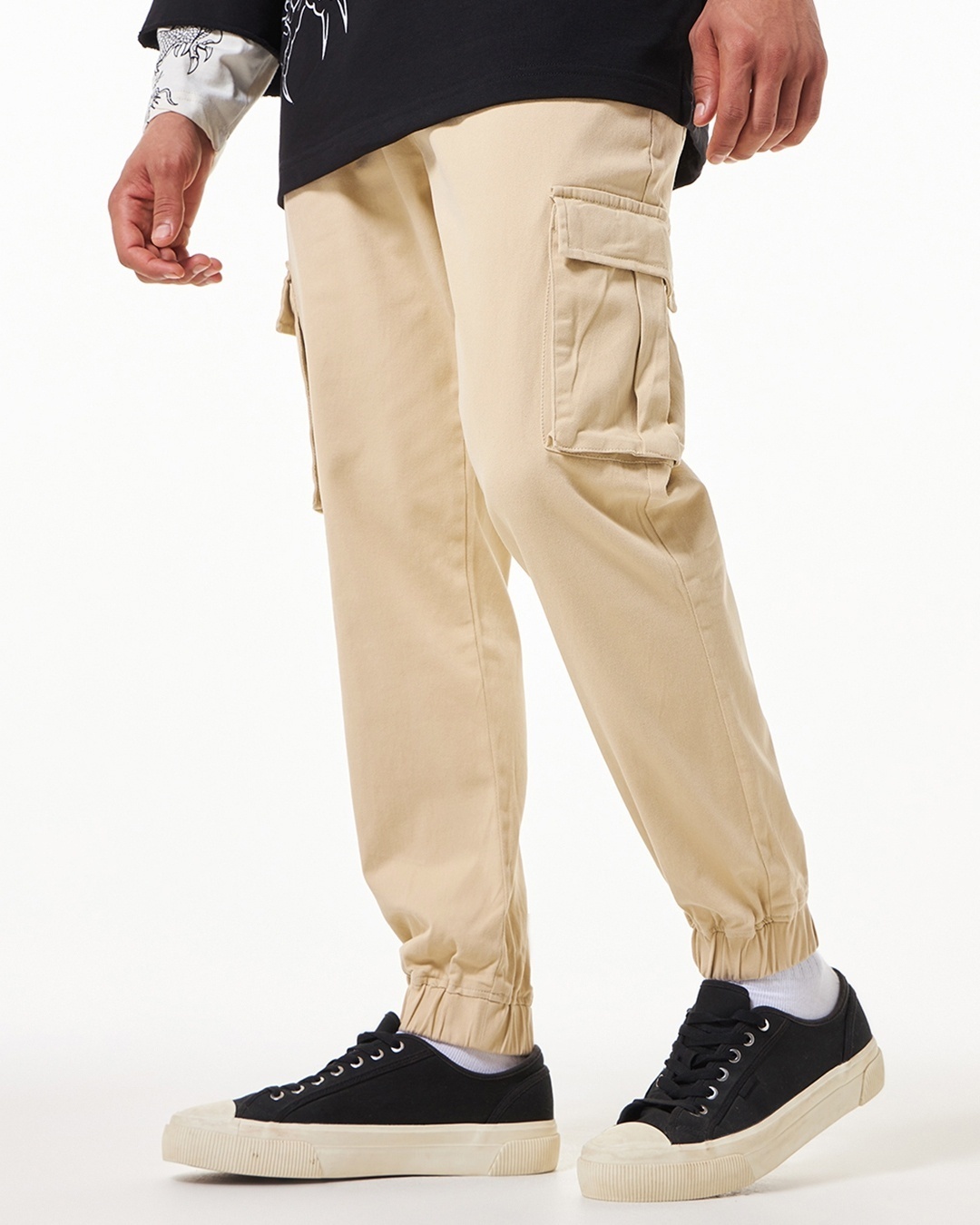 man styled a beige joggers with black sneakers