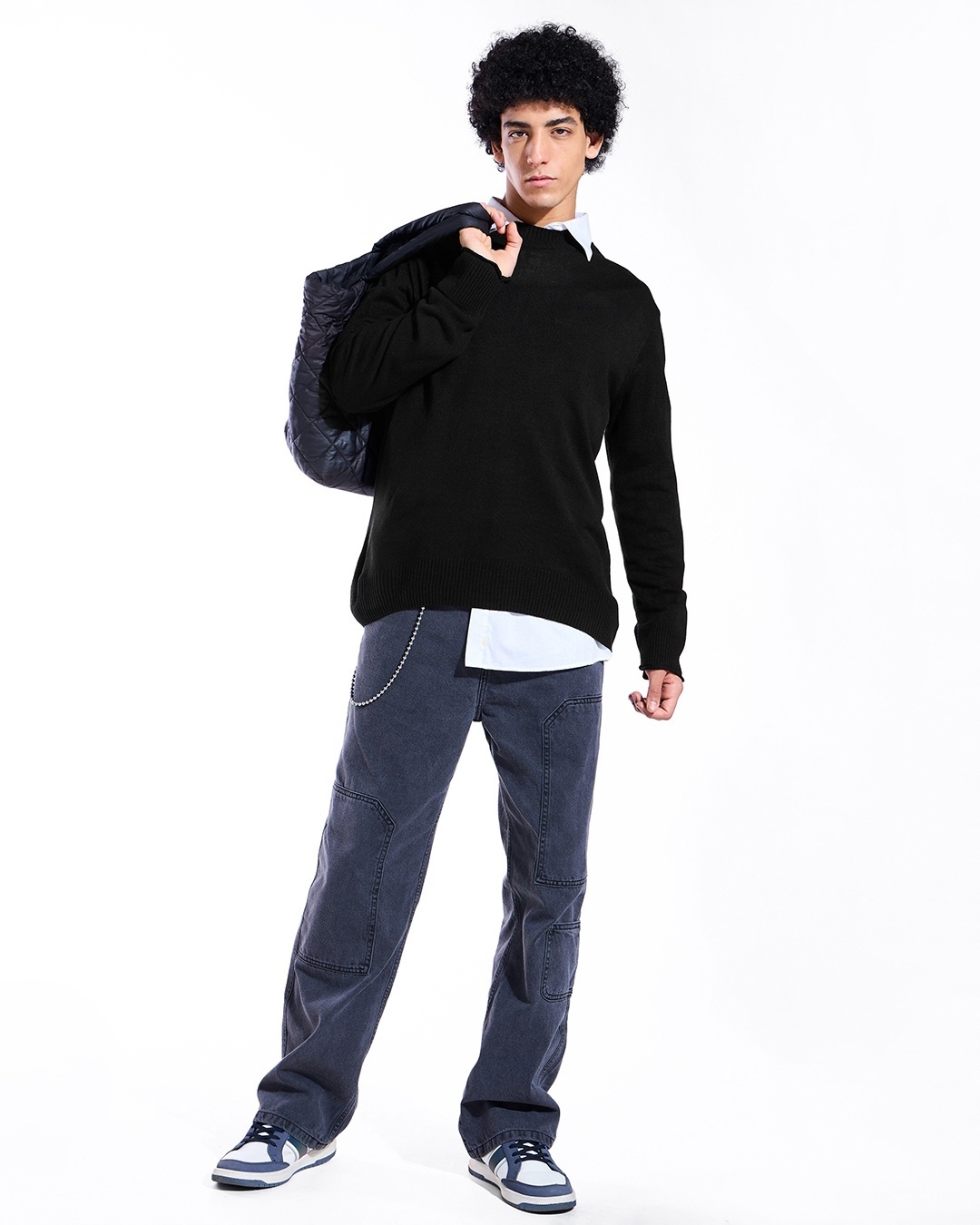 man styled a black sweater with jeans