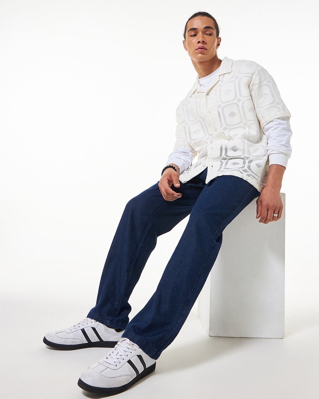 man wearing white shirt with blue jean paired with sneakers
