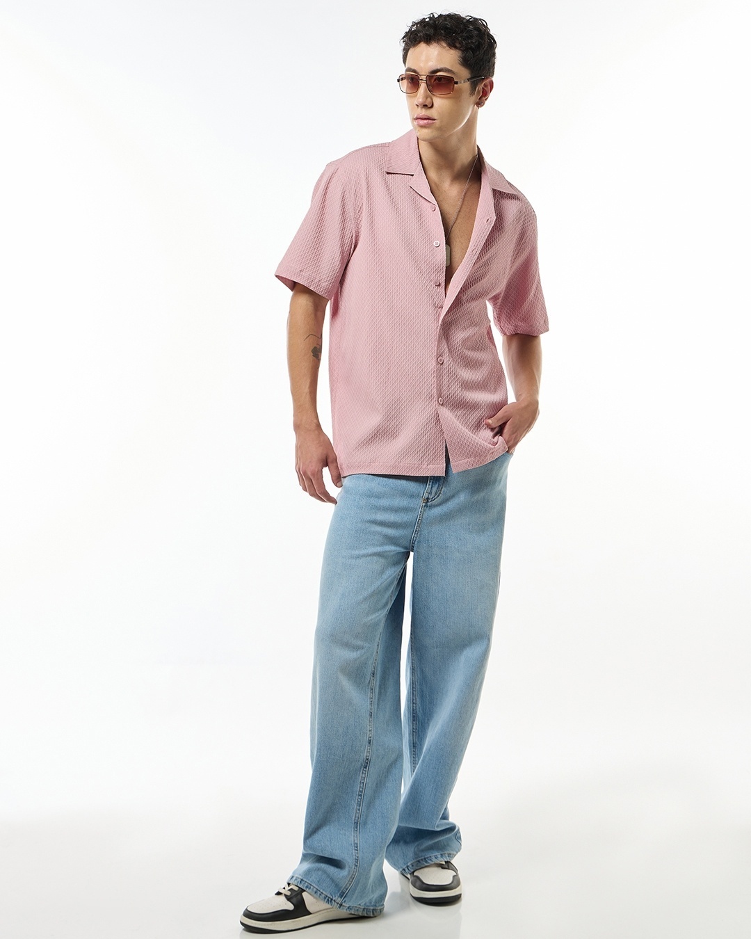 Man wearing pink shirt with blue jean

