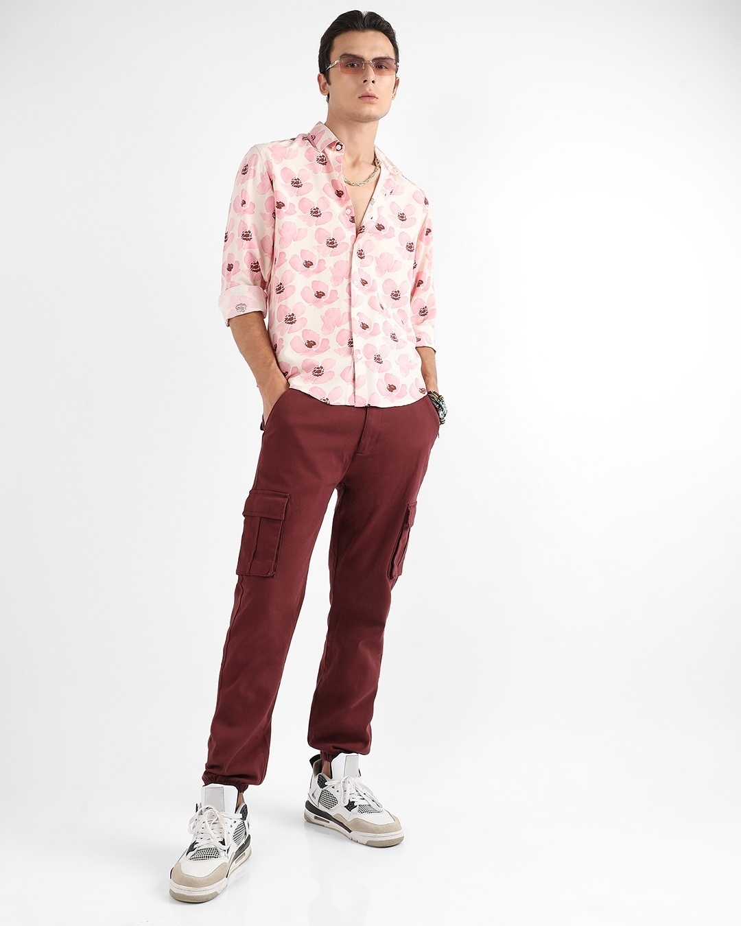 Man wearing floral pink shirt with brown pant
