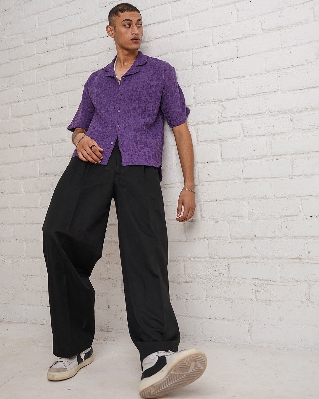 man wearing purple shirt with Black pants
