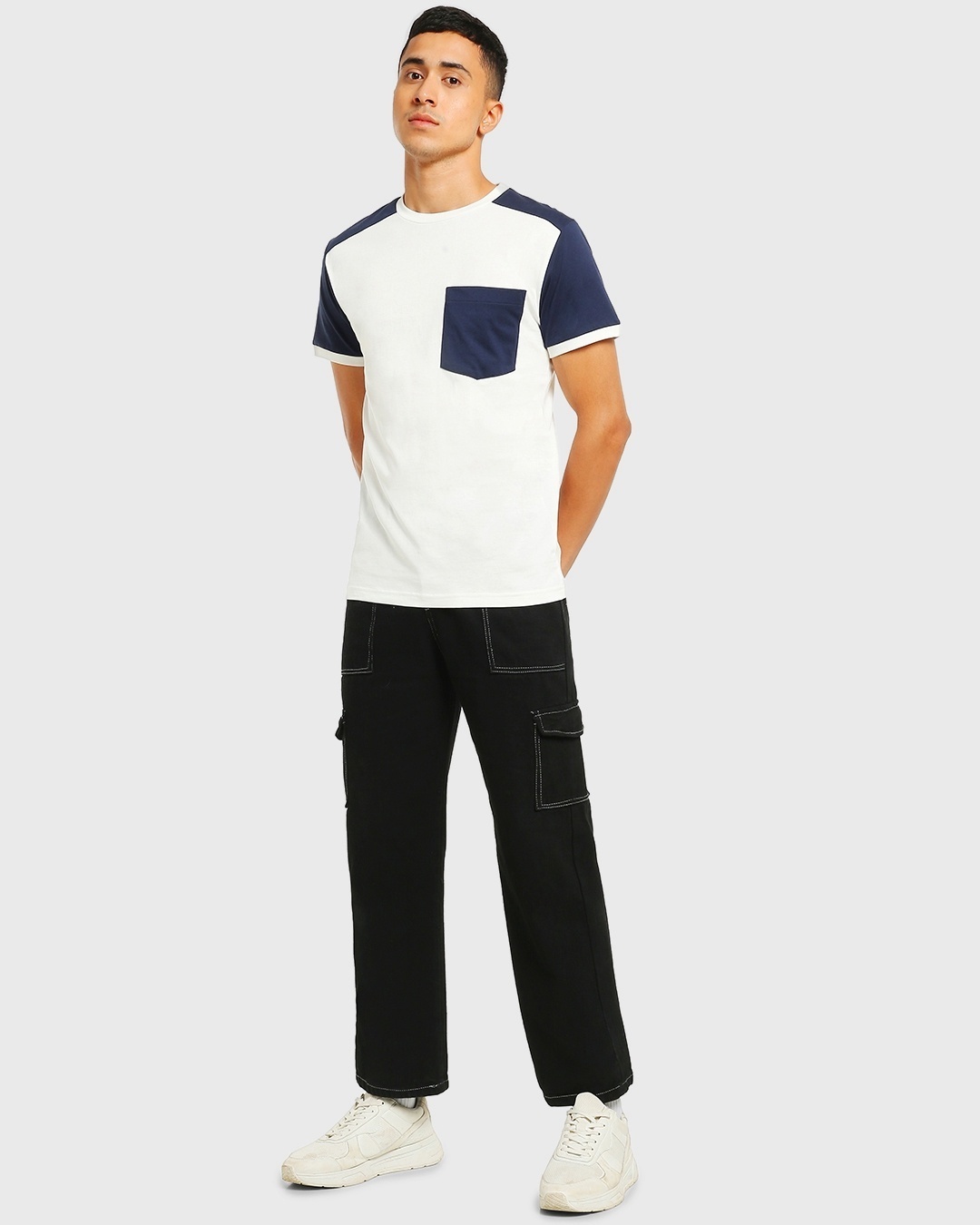 man styled a pocket tee with black pant and white sneaker