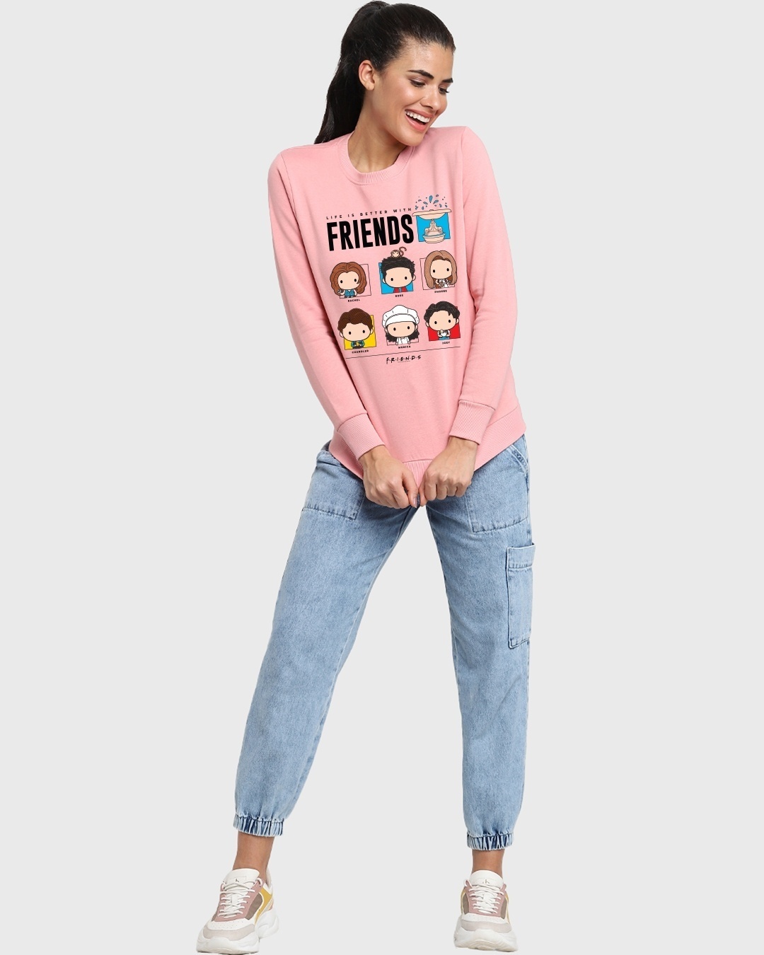 woman styled a pink sweatshirt with jeans and sneaker