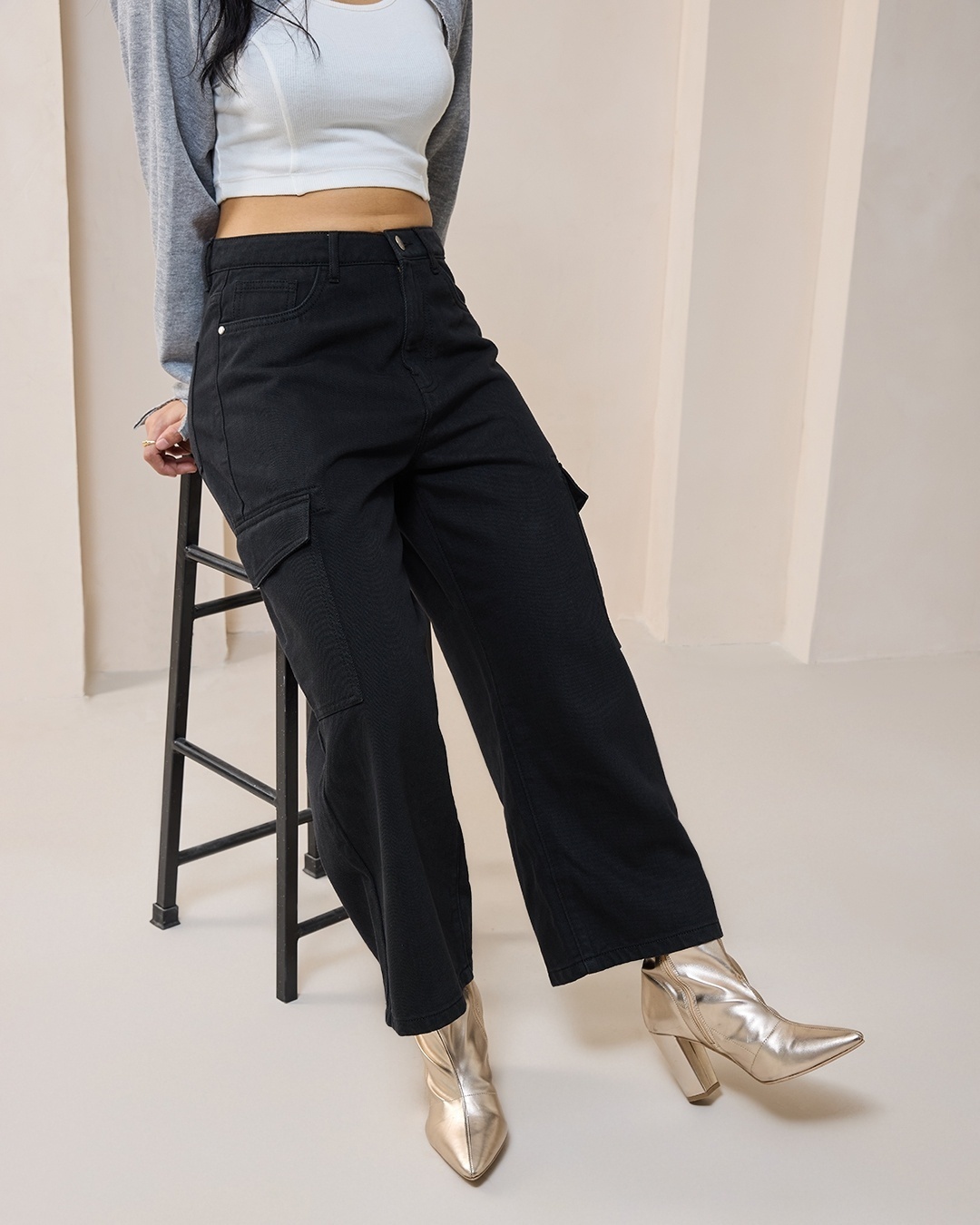 Women's Black Baggy Straight Fit Cropped Cargo Jeans paired with boots
