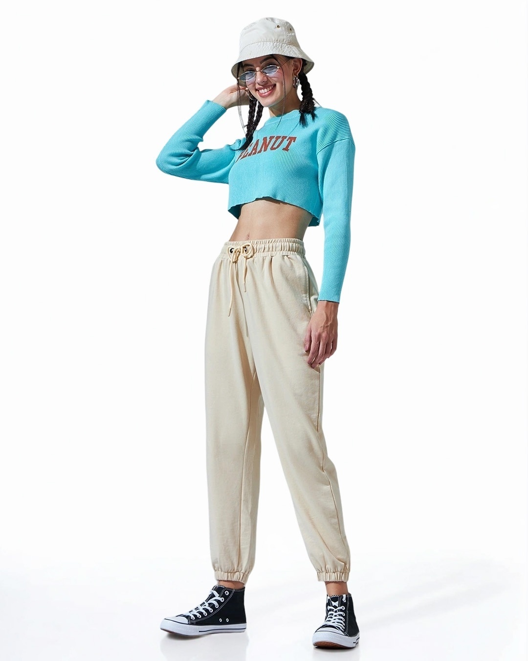 woman styled a beige joggers with cap and top