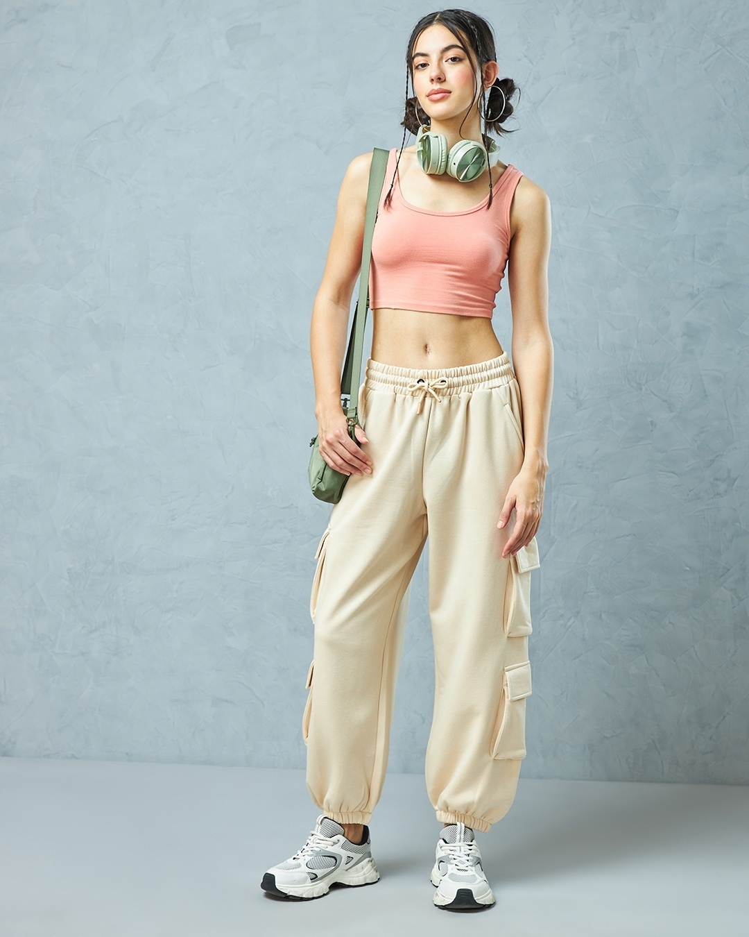 woman paired a beige joggers with sporty top and sneakers