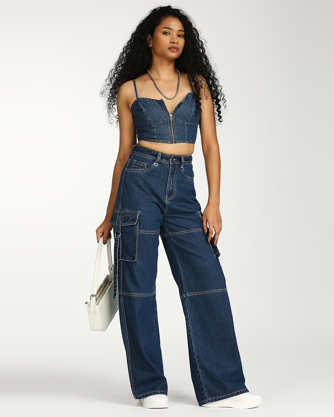 woman styled a wide leg jeans with denim top and sneakers