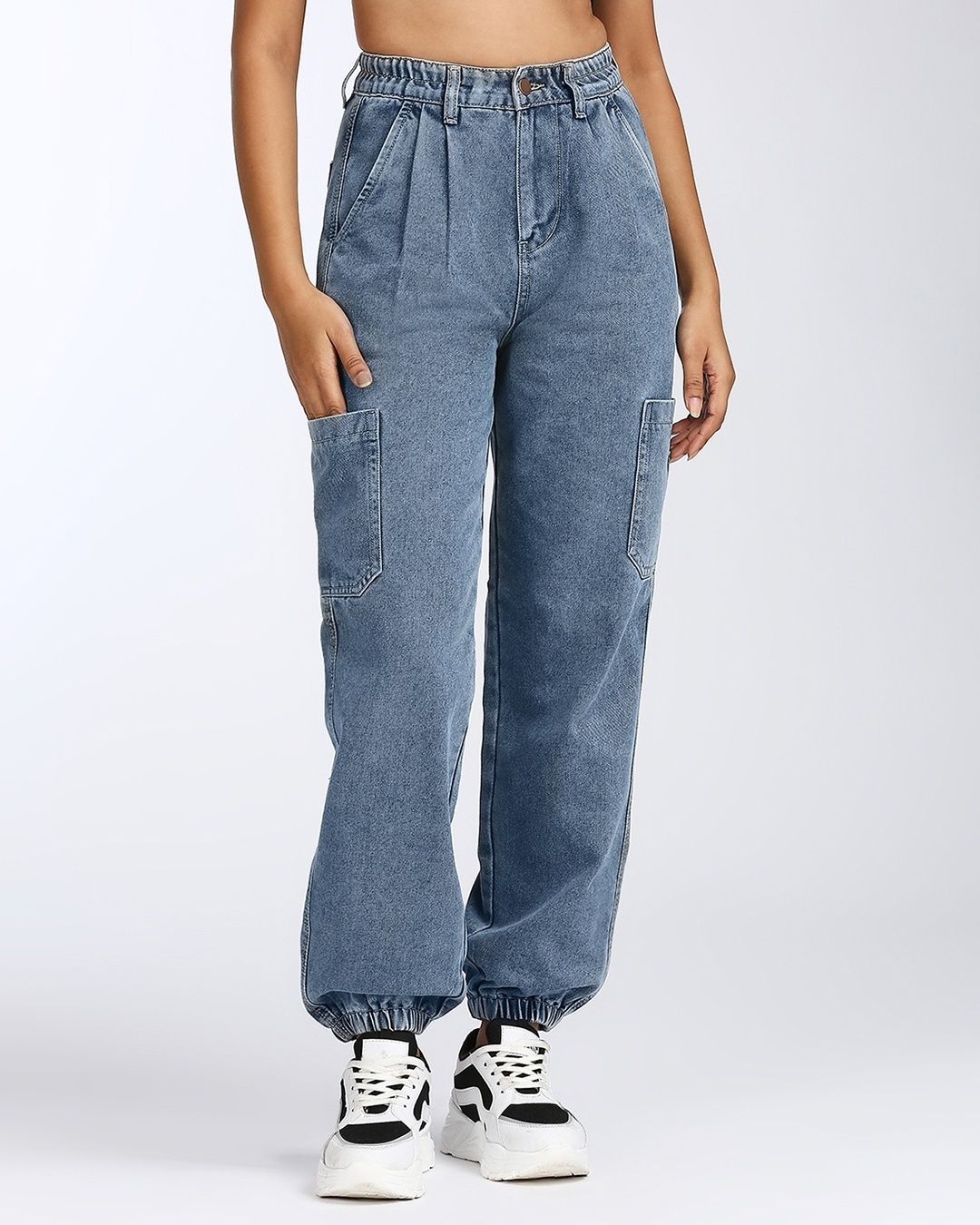 Women's Mid Blue Relaxed Fit Cargo Jogger Jeans paired with high ankle shoes