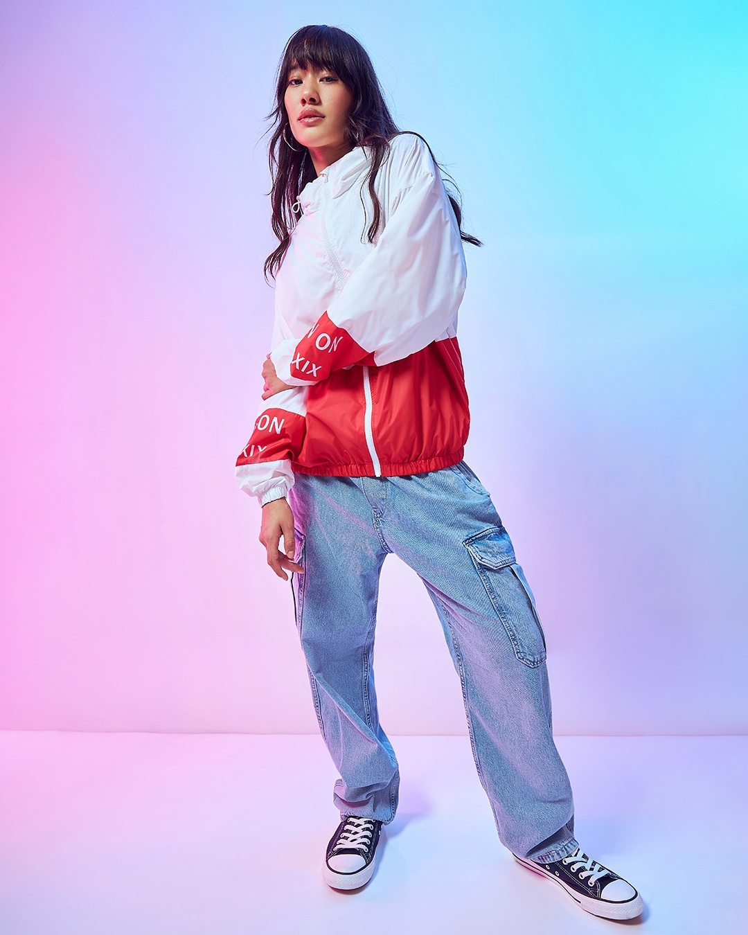 women styled a red jacket with blue jean with sneakers