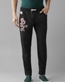 Shop Men's Black Graphic Printed Track Pants-Front