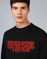 Shop Men's Jet Black Stranger Things Logo Typography Oversized T-shirt