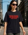 Shop Women's Jet Black Stranger Things Logo Typography Oversized T-shirt-Front